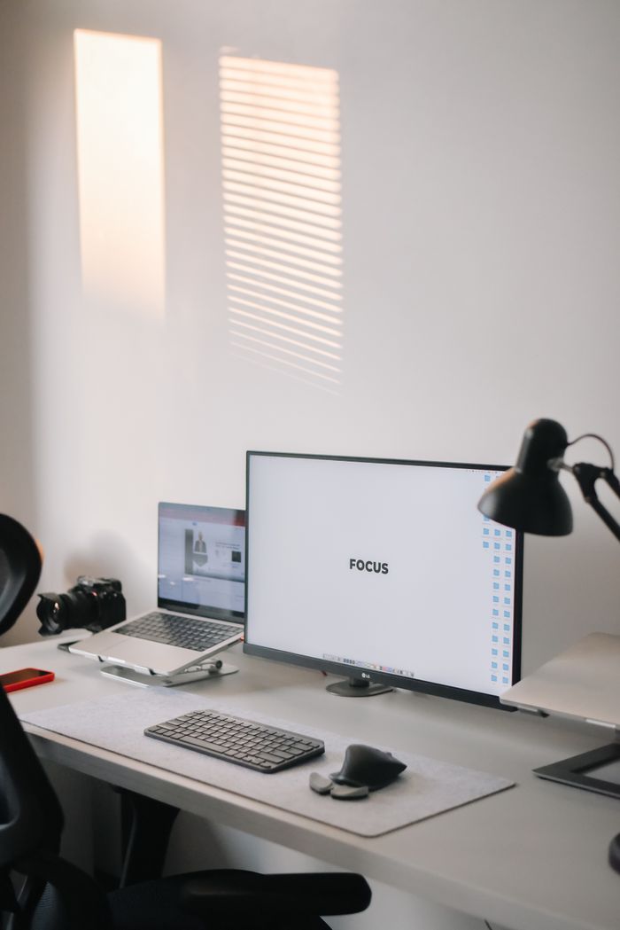 A clean and organized home office setup featuring dual monitors and a modern workspace.